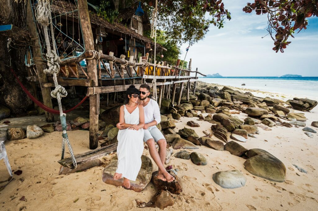 Couple in love on a swing by the sea. Couple in love on an island off the coast. Honeymoon
