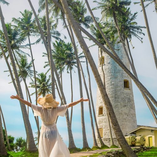 Girl in Sri Lanka on an island with a lighthouse. Selective focus.
